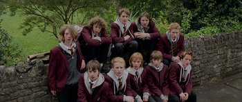 Movie still from “Hot Fuzz” (2007), directed by Edgar Wright – A group of young people in school uniforms posing for a picture; Wide shot, High angle