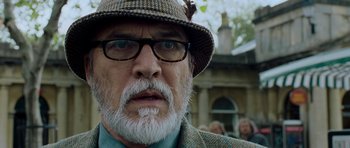 Movie still from “Hot Fuzz” (2007), directed by Edgar Wright – An older man with a beard wearing a hat and glasses; Close Up shot, Low angle