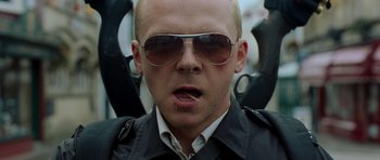 Movie still from “Hot Fuzz” (2007), directed by Edgar Wright – A man wearing sunglasses and a black jacket; Close Up shot, Low angle