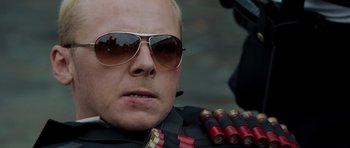 Movie still from “Hot Fuzz” (2007), directed by Edgar Wright – A person wearing sunglasses; Close Up shot, Over the shoulder angle