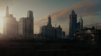 Movie still from “A League of Their Own” (2022), created by Abbi Jacobson – A view of a city skyline at sunset; Extreme Wide shot, High angle