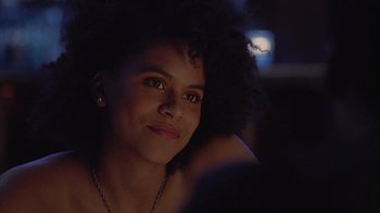Movie still from “Atlanta” (2016), created by Donald Glover – A beautiful young woman with a large afro sitting in front of a window; Close Up shot, Over the shoulder angle