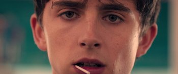 Movie still from “Hot Summer Nights” (2017), directed by Elijah Bynum – A person with a cigarette in his mouth; Extreme Close Up shot, Low angle