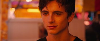 Movie still from “Hot Summer Nights” (2017), directed by Elijah Bynum – A young man's face in the dark; Close Up shot, Over the shoulder angle