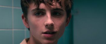 Movie still from “Hot Summer Nights” (2017), directed by Elijah Bynum – A young man's face with blue eyes; Close Up shot, Over the shoulder angle