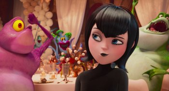 Movie still from “Hotel Transylvania 4: Transformania” (2022), directed by Jennifer Kluska – A woman with black hair standing in front of a table; Medium shot, Over the shoulder angle