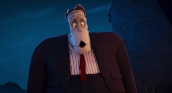 Movie still from “Hotel Transylvania 4: Transformania” (2022), directed by Jennifer Kluska – A man in a suit and tie with a dog mask on his head; Medium shot, Low angle
