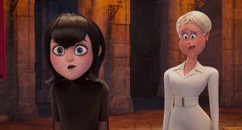 Movie still from “Hotel Transylvania 4: Transformania” (2022), directed by Jennifer Kluska – Two animated women standing next to each other in front of a building; Close Up shot, Over the shoulder angle