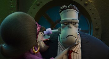 Movie still from “Hotel Transylvania 4: Transformania” (2022), directed by Jennifer Kluska – A man and a woman dressed like frankensteins monster; Medium shot, Low angle