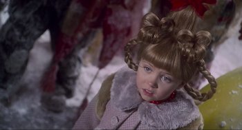 Movie still from “How the Grinch Stole Christmas” (2000), directed by Ron Howard – A little girl in a fur coat with a bow in her hair; Close Up shot, High angle
