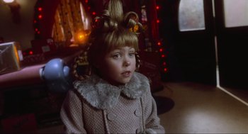 Movie still from “How the Grinch Stole Christmas” (2000), directed by Ron Howard – A little girl in a fur coat with a strange hair style; Close Up shot, Over the shoulder angle