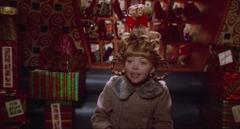Movie still from “How the Grinch Stole Christmas” (2000), directed by Ron Howard – A young girl in a costume with a bow on her head; Close Up shot, Over the shoulder angle