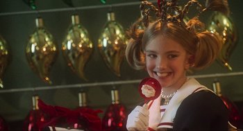 Movie still from “How the Grinch Stole Christmas” (2000), directed by Ron Howard – A young girl holding a lollipop in her hand; Close Up shot, Over the shoulder angle