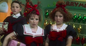 Movie still from “How the Grinch Stole Christmas” (2000), directed by Ron Howard – Two girls in red bows are standing next to each other; Close Up shot, Low angle