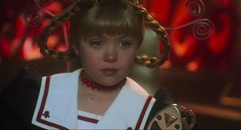 Movie still from “How the Grinch Stole Christmas” (2000), directed by Ron Howard – A young girl wearing a red necklace and a white shirt; Close Up shot, Over the shoulder angle
