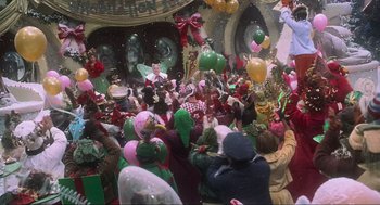 Movie still from “How the Grinch Stole Christmas” (2000), directed by Ron Howard – A group of people gathered in a room with balloons; Extreme Wide shot, High angle