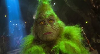 Movie still from “How the Grinch Stole Christmas” (2000), directed by Ron Howard – A person dressed as the grinch from how the grinch stole christmas; Close Up shot, Low angle