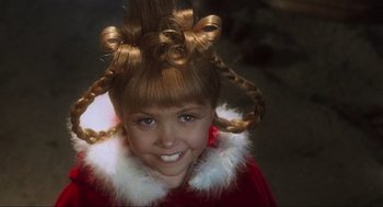 Movie still from “How the Grinch Stole Christmas” (2000), directed by Ron Howard – A young girl in a red dress with long blonde hair; Close Up shot, High angle
