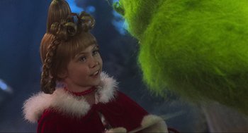Movie still from “How the Grinch Stole Christmas” (2000), directed by Ron Howard – A young girl dressed up as the grinch; Close Up shot, Over the shoulder angle