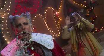 Movie still from “How the Grinch Stole Christmas” (2000), directed by Ron Howard – A man in a red coat and a woman in a red coat; Close Up shot, Over the shoulder angle