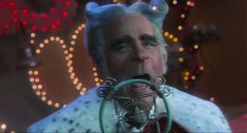 Movie still from “How the Grinch Stole Christmas” (2000), directed by Ron Howard – An older man with a strange look on his face; Close Up shot, Low angle