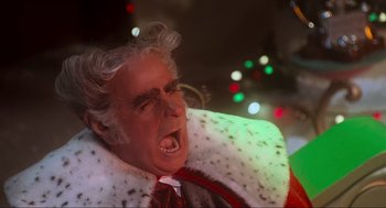Movie still from “How the Grinch Stole Christmas” (2000), directed by Ron Howard – An old man in a suit and tie with a white beard; Close Up shot, Low angle