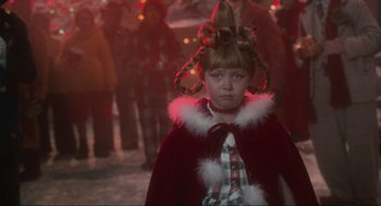 Movie still from “How the Grinch Stole Christmas” (2000), directed by Ron Howard – A young girl dressed as a little red riding hood; Close Up shot, Over the shoulder angle