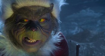 Movie still from “How the Grinch Stole Christmas” (2000), directed by Ron Howard – A person wearing a grinch mask; Extreme Close Up shot, Low angle