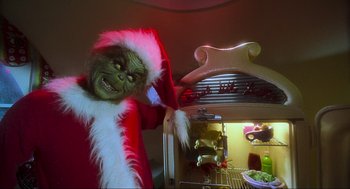 Movie still from “How the Grinch Stole Christmas” (2000), directed by Ron Howard – A person dressed up as the grinch in front of an oven; Medium shot, Low angle
