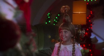 Movie still from “How the Grinch Stole Christmas” (2000), directed by Ron Howard – A young girl in a pink dress with pigtails; Close Up shot, Over the shoulder angle