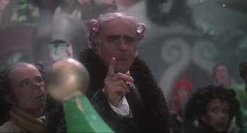 Movie still from “How the Grinch Stole Christmas” (2000), directed by Ron Howard – An older man with hair curlers on his head; Close Up shot, Over the shoulder angle