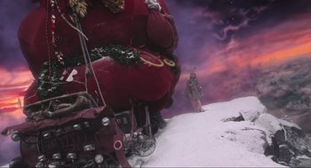 Movie still from “How the Grinch Stole Christmas” (2000), directed by Ron Howard – A man standing in the snow next to a large red sack; Extreme Wide shot, Low angle