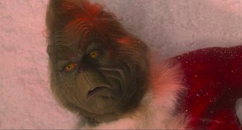 Movie still from “How the Grinch Stole Christmas” (2000), directed by Ron Howard – The grinch is laying down in the snow; Extreme Close Up shot, Low angle