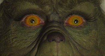 Movie still from “How the Grinch Stole Christmas” (2000), directed by Ron Howard – View of the eyes of a green creature; Extreme Close Up shot, Overhead angle