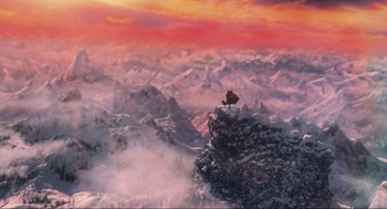 Movie still from “How the Grinch Stole Christmas” (2000), directed by Ron Howard – A bird sitting on top of a snowy mountain; Extreme Wide shot, Overhead angle