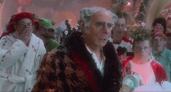Movie still from “How the Grinch Stole Christmas” (2000), directed by Ron Howard – An older man in a black and red jacket; Close Up shot, Over the shoulder angle