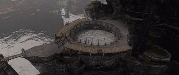 Movie still from “How to Train Your Dragon” (2010), directed by Chris Sanders – An aerial view of an outdoor area with wooden platforms; Extreme Wide shot, High angle