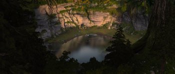 Movie still from “How to Train Your Dragon” (2010), directed by Chris Sanders – An aerial view of a lake surrounded by a cliff; Extreme Wide shot, High angle