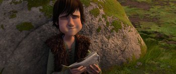 Movie still from “How to Train Your Dragon” (2010), directed by Chris Sanders – A young boy holding a fish in his hands; Medium shot, High angle