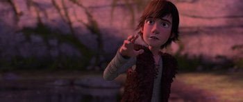 Movie still from “How to Train Your Dragon” (2010), directed by Chris Sanders – A young boy is holding his hand up to the sky; Medium shot, High angle