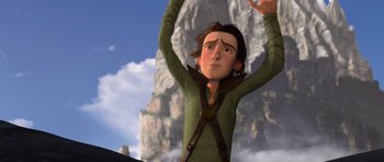 Movie still from “How to Train Your Dragon” (2010), directed by Chris Sanders – A cartoon of a person with a mountain in the background; Medium shot, Low angle