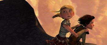 Movie still from “How to Train Your Dragon” (2010), directed by Chris Sanders – A young girl riding on the back of a black dragon; Medium shot, Low angle