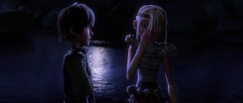 Movie still from “How to Train Your Dragon” (2010), directed by Chris Sanders – A boy and a girl are standing next to each other in the dark; Medium shot, Over the shoulder angle