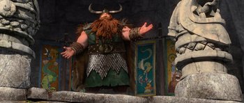 Movie still from “How to Train Your Dragon” (2010), directed by Chris Sanders – A man dressed as a viking standing in front of a wall; Medium shot, Low angle