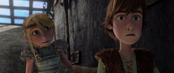 Movie still from “How to Train Your Dragon” (2010), directed by Chris Sanders – A couple of people standing next to each other in front of a wall; Close Up shot, Low angle