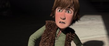 Movie still from “How to Train Your Dragon” (2010), directed by Chris Sanders – A cartoon of a boy with brown hair and a brown vest; Medium shot, Low angle