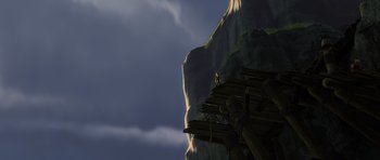 Movie still from “How to Train Your Dragon” (2010), directed by Chris Sanders – A man standing on a platform on top of a mountain; Extreme Wide shot, Overhead angle