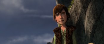 Movie still from “How to Train Your Dragon” (2010), directed by Chris Sanders – A young boy is standing next to a tree; Medium shot, Low angle