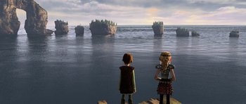 Movie still from “How to Train Your Dragon” (2010), directed by Chris Sanders – Two children standing on a pier looking out at the water; Extreme Wide shot, High angle