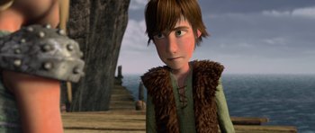 Movie still from “How to Train Your Dragon” (2010), directed by Chris Sanders – A young boy with a brown fur vest and brown shirt; Medium shot, High angle